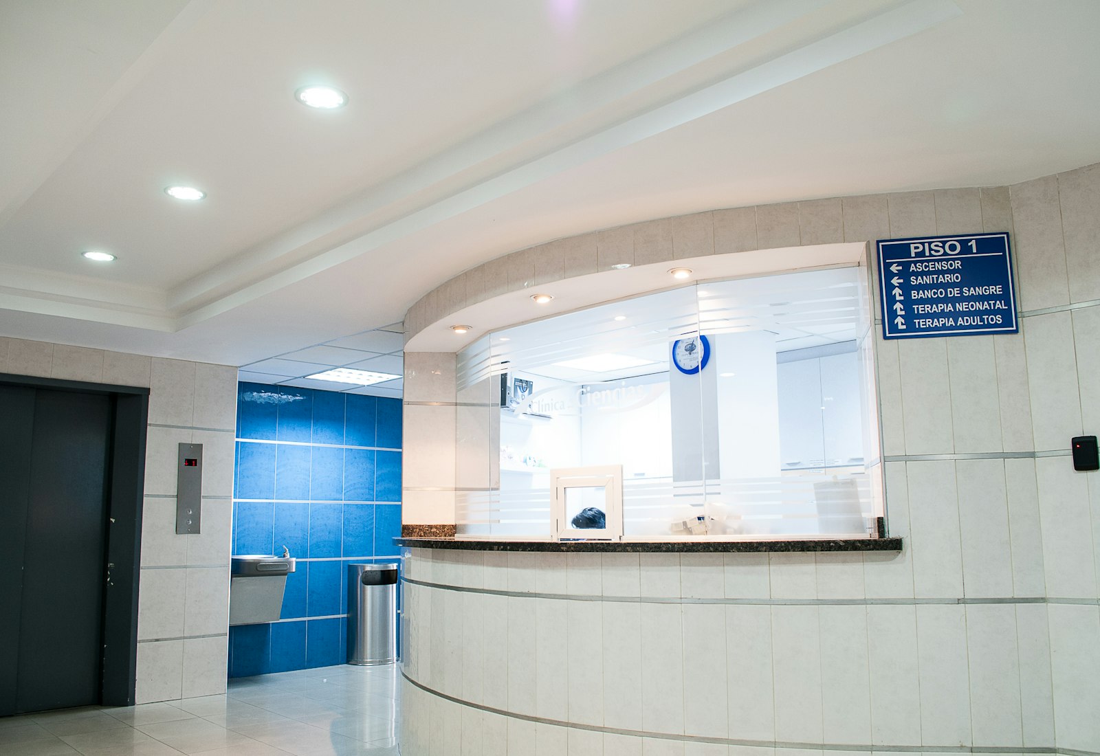 A clinic reception desk with signage (placeholder photography)